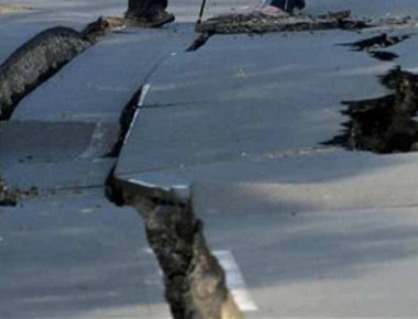 Residents stand on a split road in earthquake-hit in Mashiki, Kumamoto prefecture, southern Japan Saturday, April 16, 2016. A powerful earthquake struck southern Japan early Saturday, barely 24 hours after a smaller quake hit the same region. (Naoya Osato/Kyodo News via AP) JAPAN OUT, MANDATORY CREDIT