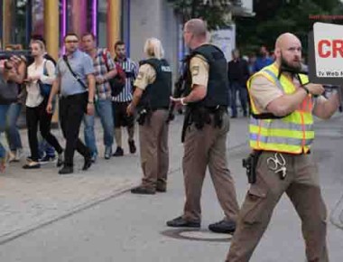 Police escort people who leave the Olympia mall in Munich, southern Germany, Friday, July 22, 2016 after shots were fired. Police said that at least six people have been killed. (AP Photo/Sebastian Widmann)