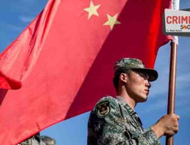 OMSK, RUSSIA - AUGUST 5, 2016: China's serviceman carries a Chinese flag during the opening ceremony for the Maintenance Battalion competition among maintenance units in the village of Cheryomushki as part of the 2016 Army Games, an international event organized by the Russian Defense Ministry. Sergei Bobylev/TASS (Photo by Sergei BobylevTASS via Getty Images)