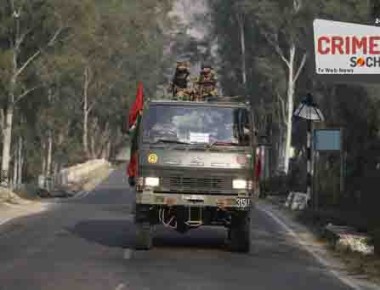 Indian army soldiers patrol a road near the site of a gunbattle in Nagrota, about 15 kilometers from Jammu, India, Tuesday, Nov. 29, 2016. Rebels fighting against Indian rule in the disputed Himalayan region of Kashmir stormed a crucial Indian military base Tuesday, triggering a fierce gunbattle, officials said. (AP Photo/Channi Anand)