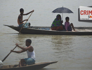 Indian villagers on boats cross flood waters at Burgaon, 80 kilometers (50 miles) east of Gauhati, Assam state, India, Wednesday, July 5, 2017. Heavy rains since the start of India's monsoon season have triggered floods and landslides in parts of the remote northeastern region, causing at least 20 deaths, authorities said Wednesday. (AP Photo/Anupam Nath)