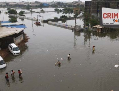 People wade through a flooded street following incessant rains, in Ahmadabad, India, Friday, July 28, 2017. Dozens of people have died in the state of Gujarat amid torrential rains. (AP Photo/Ajit Solanki)